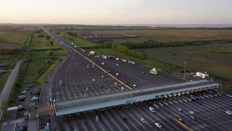 A-drone-shot-made-above-the-Hudson-Toll-in-Buenos-Aires,-Argentina,-where-cars-are-approaching-the-toll-and-going-through