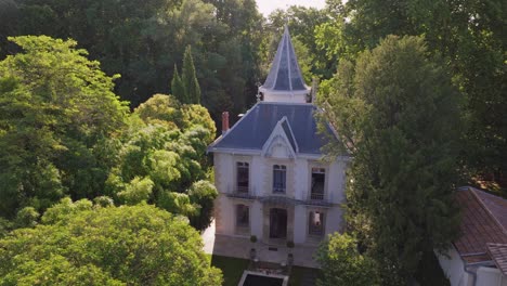 Aerial-view-of-beautiful-small-castle-near-the-Lez-river-surrounded-by-trees-in-Montpellier