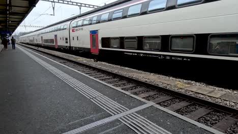 Gare-de-Genève-train-station-platform-with-people-waiting-on-their-next-train