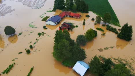 Horrific-Aerial-4K-Drone-footage-of-houses-in-Podravje,-Slovenia,-during-August-floods