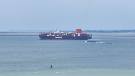 Barges-And-Cargo-Vessel-Travelling-Through-Western-Scheldt-Estuary-In-Zeeland,-Netherlands