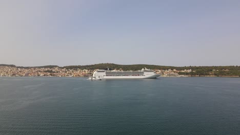 Huge-MSC-cruise-ship-in-Argostoli,-island-Kefalonia,-Greece,-aerial-forward