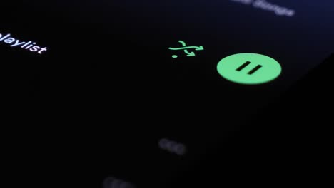 Press-play-and-shuffle-button-of-Spotify-app-on-smartphone-screen,-close-up