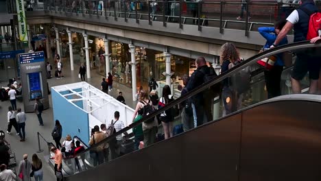 Down-the-escalators-within-St-Pancreas,-London,-United-Kindom