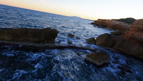 Scenic-FPV-aerial-drone-flying-along-the-rugged-Mediterranean-Coast-in-Spain