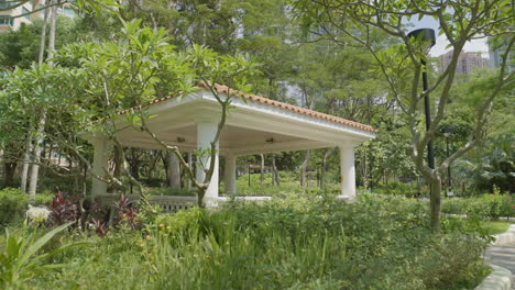 Push-in-to-gazebo-open-air-shade-structure-with-beautiful-benches-and-white-walls