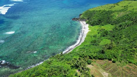 tropical-shoreline-in-philippines,-strong-waves-crash-on-shore,-panoramic-aerial