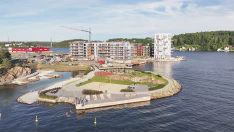 Aerial-View-Of-Lokholmen-Playground-And-Bathing-Spot-With-Building-Under-Construction-In-The-Background-In-Arendal,-Norway