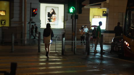 People-and-public-transportation-cross-the-Zebra-light-of-night-on-one-of-the-Hongkong-streets