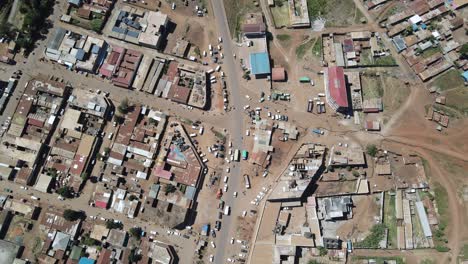 Busy-street-in-centre-of-African-town,-car-traffic-aerial-top-down-view