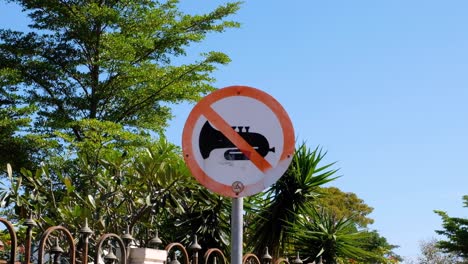 Close-up-of-noise-control-sign-post-for-no-music-outside-a-church-in-Dili,-Timor-Leste