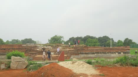 Wide-shot-of-Construction-Labourers-working-on-excavation-and-restoration-work-on-the-ruins-of-Nalanda-Mahavihara-an-ancient-Buddhist-monastic-university-that-was-demolished-by-Mughal-Invaders