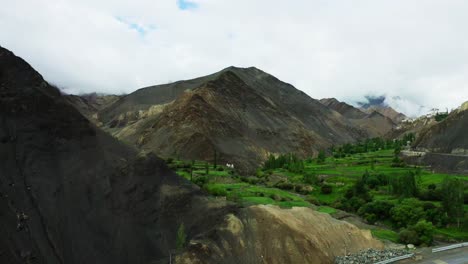 Aerial-Cinematic-view-of-a-scenic-road-crossing-the-valley-among-the-mountains,-Leh,-Ladakh,-India