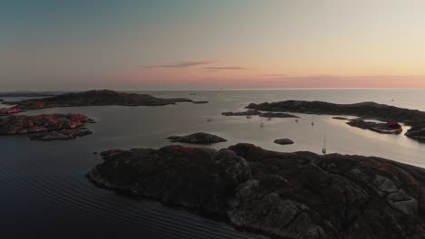 drone-flies-over-Swedish-archipelago-at-sunset-in-skarhamn