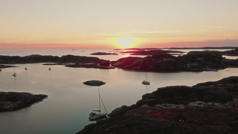 drone-flies-over-Swedish-archipelago-at-sunset-in-skarhamn