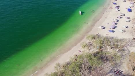 Conchal-Beach-Shore-Costa-Rica-With-Blue-Ocean-And-Tourists-On-Sandy-Shore,-4K-Aerial-Drone