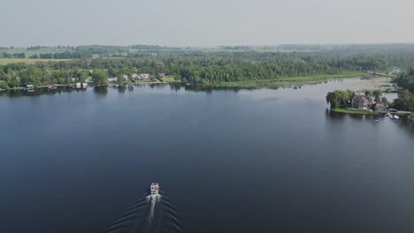 View-From-Above-Of-Motorboat-Navigating-On-Calm-Lake