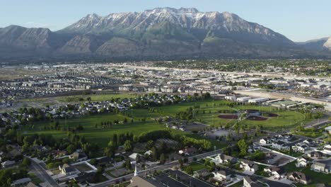 Mount-Timpanogos-Snow-Capped-Wasatch-Mountain-in-Utah-County,-Aerial-Tilt-up-Reveal