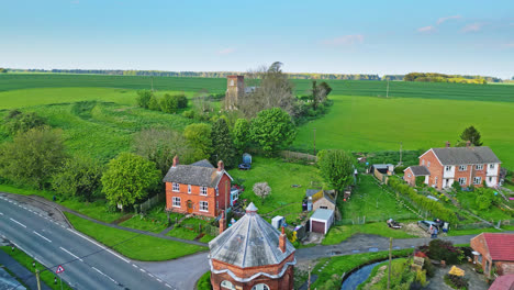 Drone-footage-presents-Burwell-village's-past-as-medieval-market-town—countryside-fields,-traditional-red-brick-houses,-and-the-abandoned-Saint-Michael-parish-church-on-Lincolnshire's-Wold-Hills