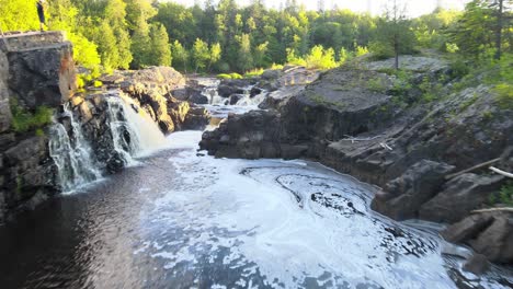 People-hiking-and-starring-at-a-waterfall-and-beautiful-forest-in-Jay-Cooke-State-Park,-Minnesota