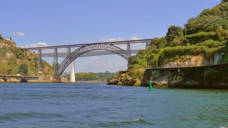 Astounding-Architecture-Of-The-Oldest-Maria-Pia-Bridge-View-From-The-Boat-At-Douro-River-In-Porto,-Portugal