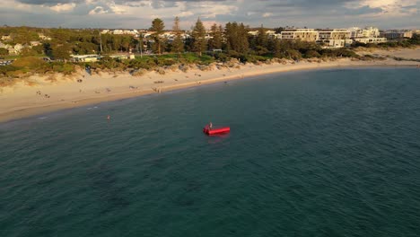 People-playing-on-red-floating-sea-platform-at-South-Beach-in-Fremantle