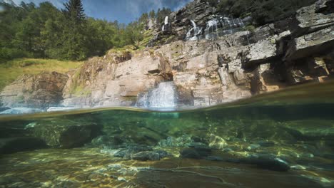 A-meditative-video-shows-the-natural-beauty-of-a-river,-with-clear-water-and-a-waterfall-on-unusual-square-cliffs