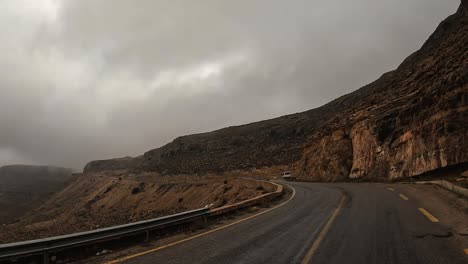 Driving-on-foggy-mountain-road-of-Tunisia-on-cloudy-rainy-day,-driver-point-of-view