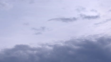 Clouds-flying-across-sky-slowly,-time-lapse-view