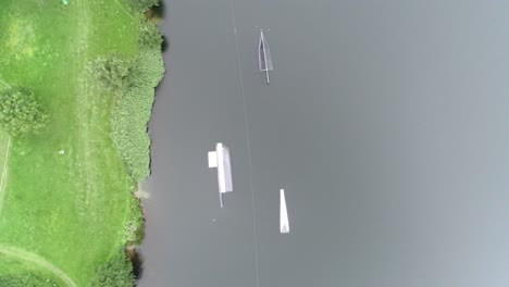 Aerial-drone-shot-of-waterboard-jumps-at-a-watersport-park
