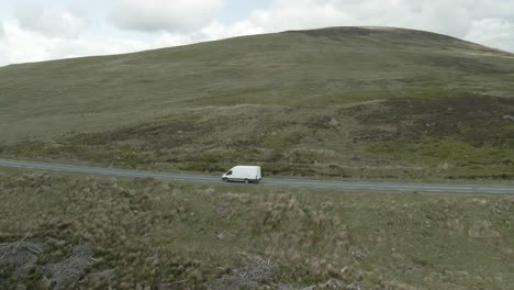 Delivery-Van-Delivering-Goods-To-Customers-Driving-On-Mountain-Pass-In-Wickolow,-Ireland