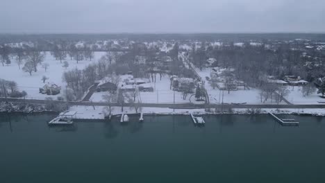 Grosse-Ile-Island-estates-covered-in-white-snow,-aerial-drone-view
