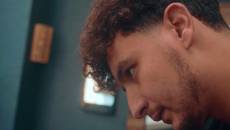 Amazing-close-up-slow-motion-shot-of-a-professional-barber-as-he-gives-an-afro-haircut-to-a-young-afro-man-in-4K