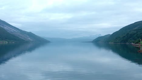 Calm-Water-Of-Fjord-Between-The-Mountain-Hills