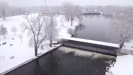 Iconic-bridge-with-water-step-on-cold-winter-day,-aerial-drone-view