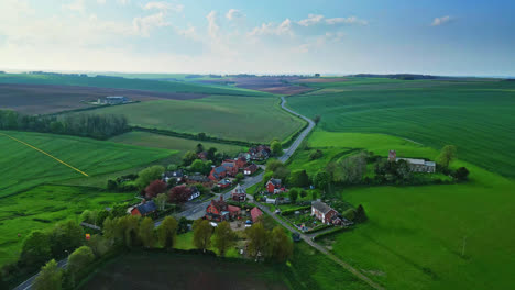 Drone-captures-Burwell-village,-formerly-medieval-market-town—countryside-fields,-aged-red-brick-homes,-and-the-obsolete-Saint-Michael-parish-church-atop-Lincolnshire's-Wold-Hills