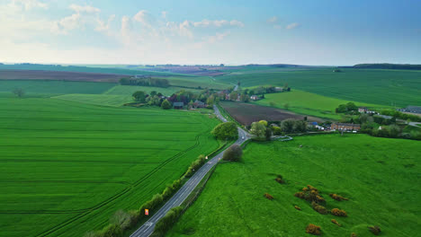 Aerial-drone-perspective-presents-Burwell-village,-once-medieval-market-town,-with-country-fields,-traditional-red-brick-houses,-and-the-unused-Saint-Michael-parish-church-on-Lincolnshire's-Wold-Hills
