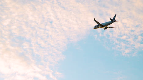 LOT-Polish-Airlines-Airplane-Ascending-Into-Sunset-Sky-With-Pink-Clouds