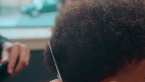 Beautiful-close-up-slow-motion-shot-of-afro-haircut-in-city-barbershop
