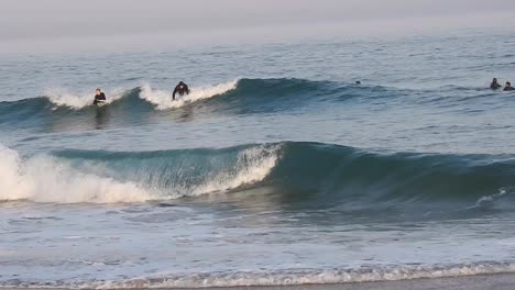 Surfer-on-hydrofoil-surfboard-riding-blue-ocean-wave