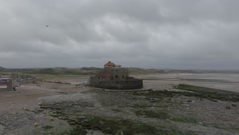 Drone-shot-of-Fort-D'Ambleteuse-during-low-tide-on-stormy-day