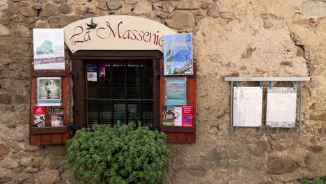 In-a-small-town-in-Southern-France,-a-window-of-a-second-hand-bookstore-with-mottled-walls