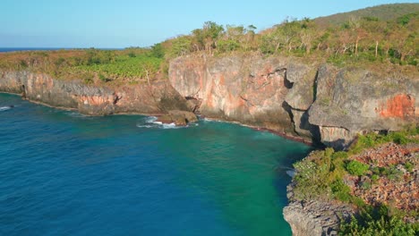 Drone-view-Cliffs-and-ocean-waves-near-El-Cabito-Restaurant-in-Las-Galeras,-Samana,-Dominican-Republic