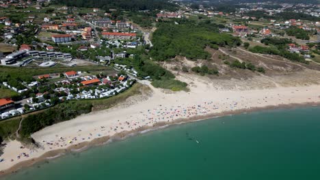 Aerial-Footage-of-Spanish-Beachfront-Resort-with-Jade-Water-and-Forests