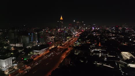 Atlanta-Gebäude-In-Der-Innenstadt-Bei-Nacht,-Zusammen-Mit-Autos,-Die-Auf-Der-Autobahn-Fahren