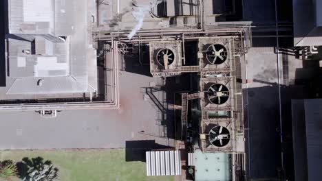Smoke-and-seam-coming-out-of-the-roof-of-a-cotton-factory---straight-down-aerial-view