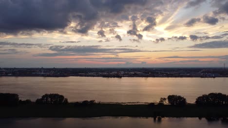 Aerial-View-Of-Calm-Evening-Sunset-With-Clouds-Over-Saint-Lawrence-River,-Canada-With-Silhouette-Of-Riverbank