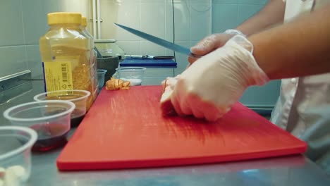 cook-puts-a-piece-of-meat-on-chopping-board