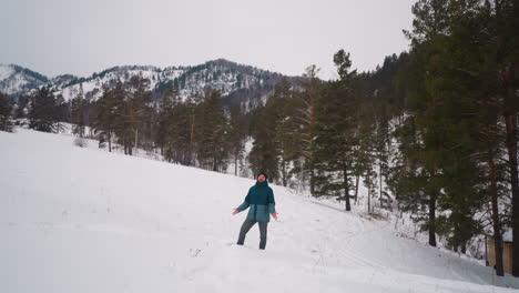 Man-enjoys-winter-nature-of-Gorny-Altai-standing-on-slope