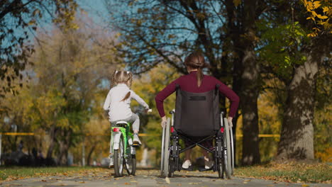 Elder-sister-with-injury-and-younger-girl-on-bicycle-in-park